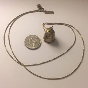 Brassy gold necklace with gold thimble